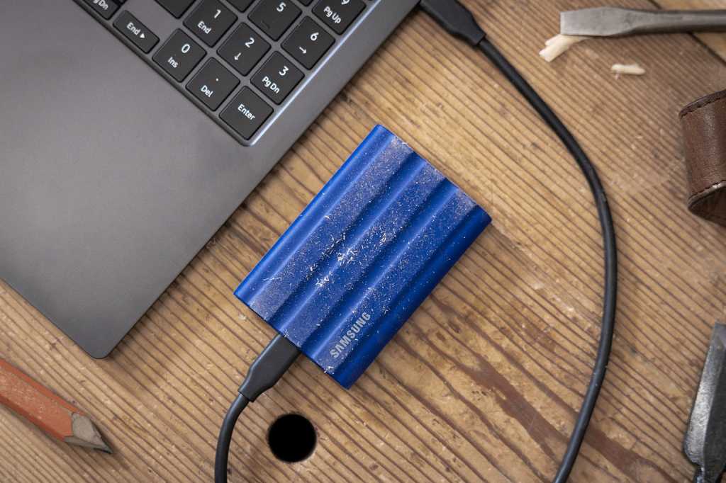 Samsung T7 Shield Portable Ssd Lifestyle Shot On Wooden Table.jpg