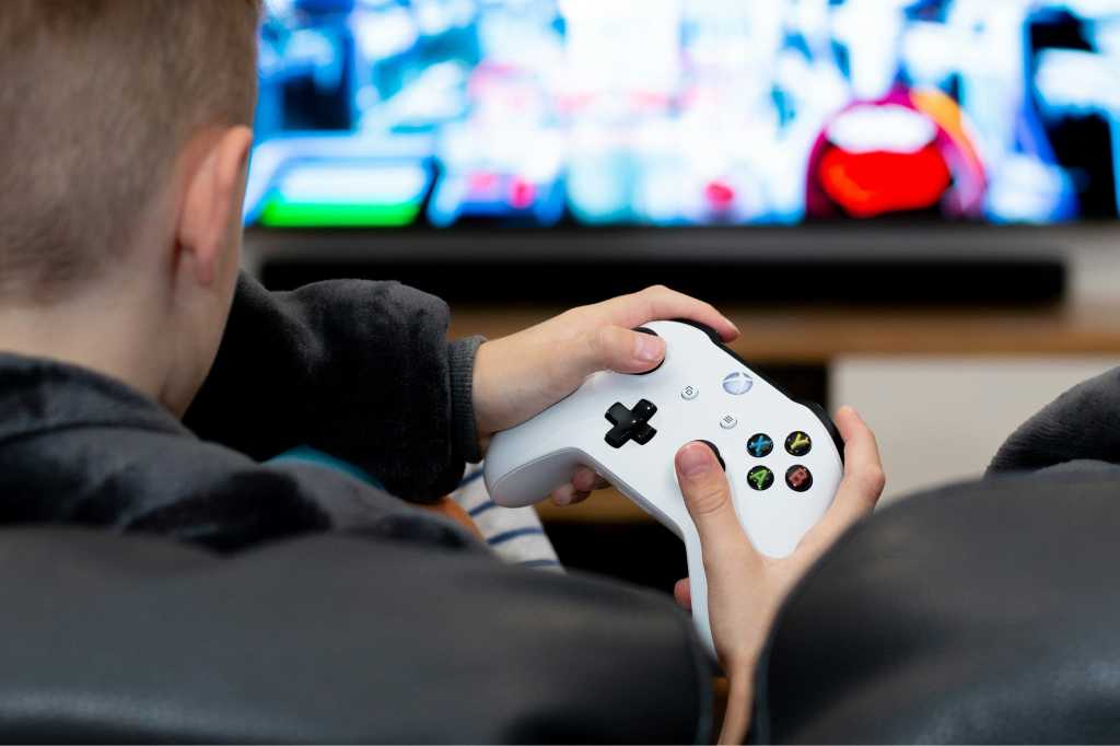 Man Holding Xbox Controller While Playing Games On Tv 2.jpg