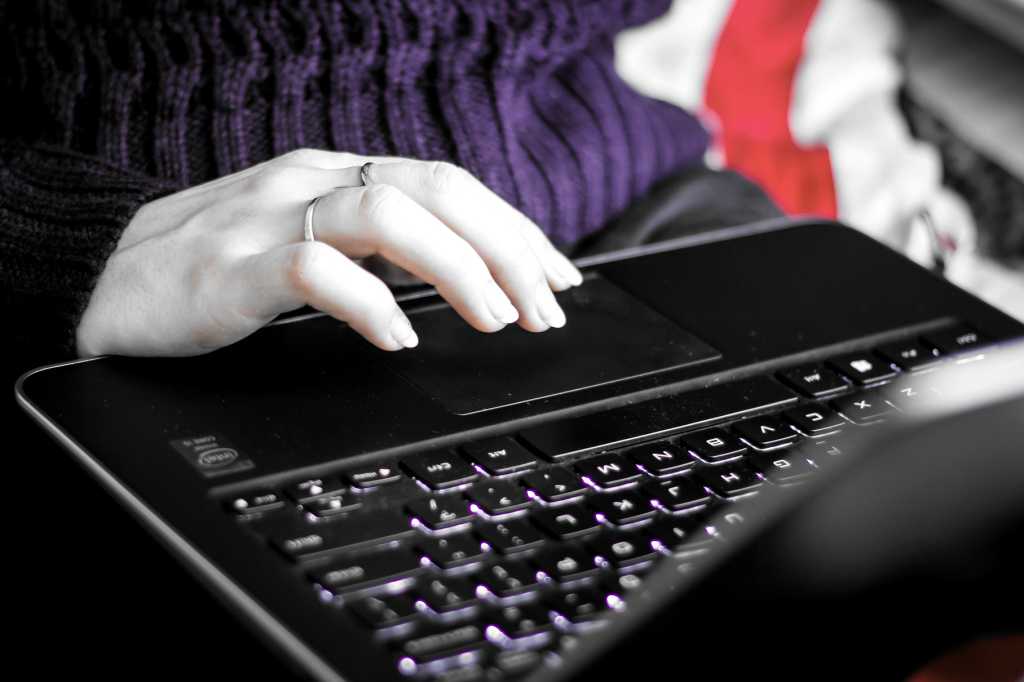 Student Girl Working On Black Laptop Using The Touchpad Colorshifted.jpg