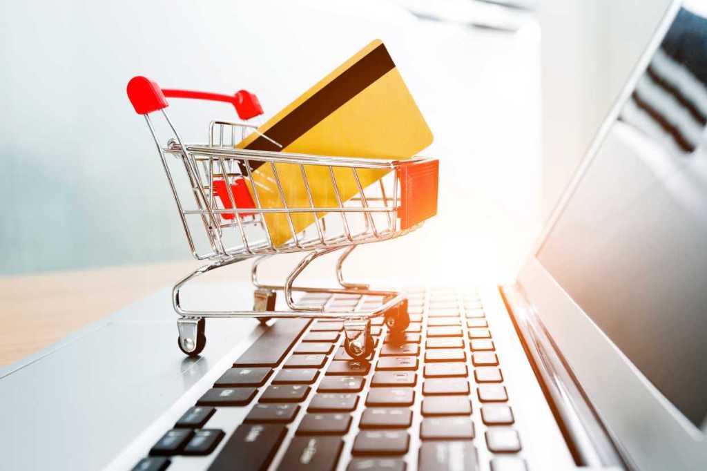 Miniature shopping cart with credit card on computer keyboard sales shopping purchases delivery by b.jpeg