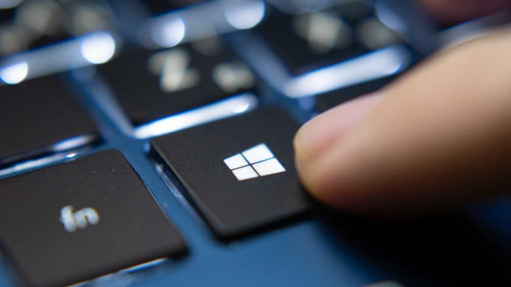 Closeup finger pressing windows key on laptop keyboard.jpg